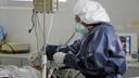 A nurse is taking respiratory secretions of a patient through a nasopharyngeal swab.