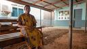 Gladys Nyarko waits under an iron roof outside the Accident & Emergency center of the Holy Family Hospital in Techiman.