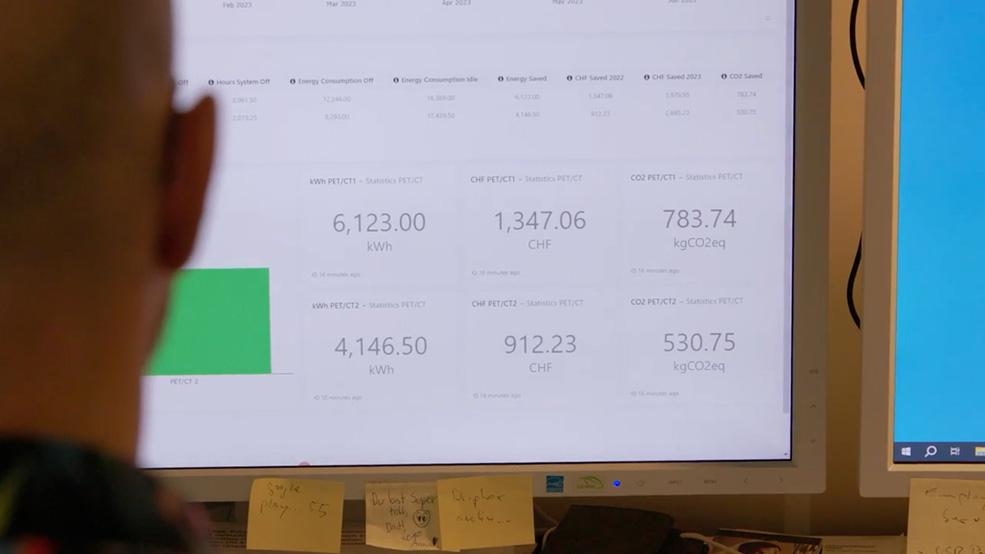 A person checking energy consumption analytics of a radiology department on a computer screen.