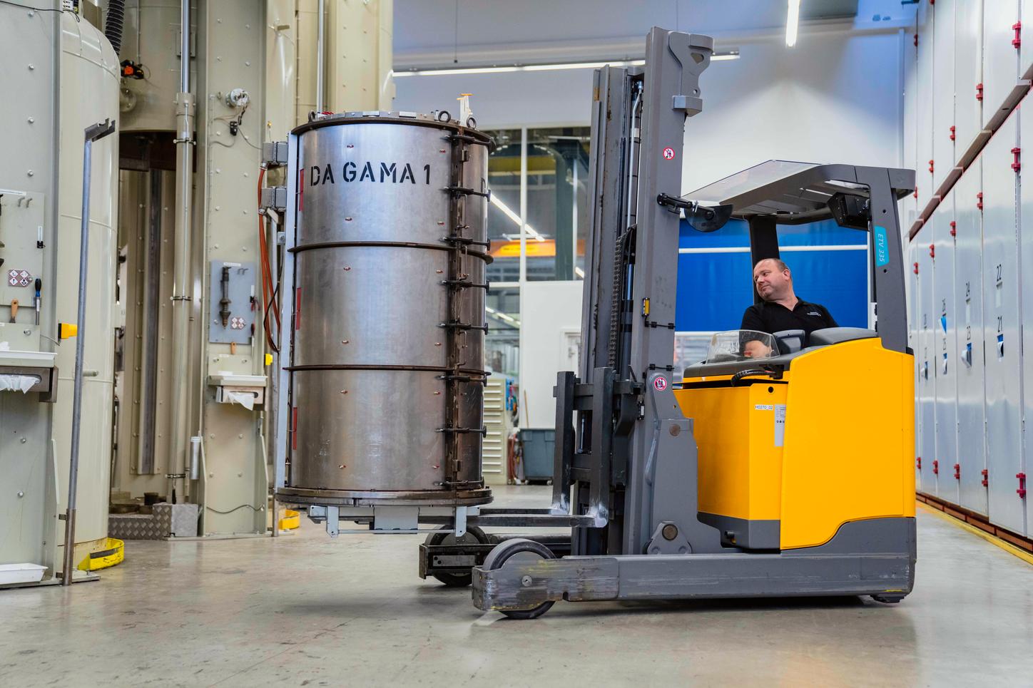 A just-cast gradient coil is driven into a tempering furnace for hardening.