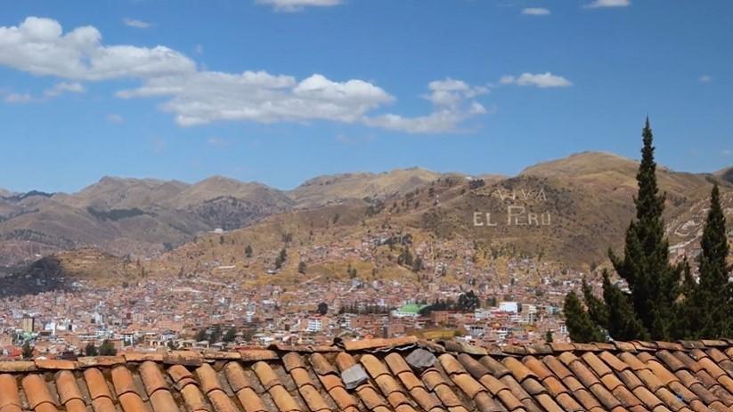 Bird’s eye view of the Andes with a sign in the mountains saying “Viva El Peru”