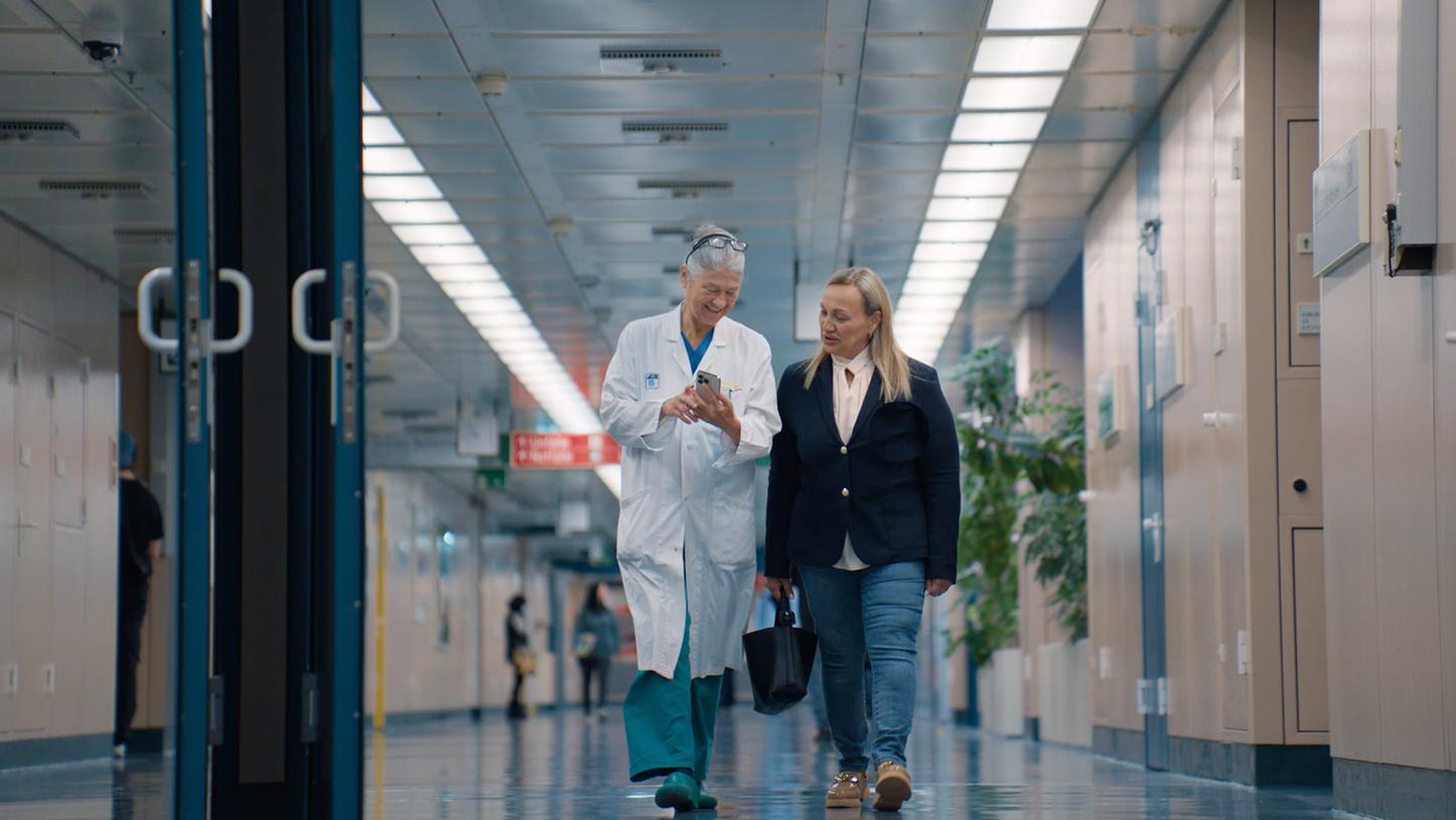 Doctor and patient walking through a hospital corridor