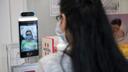 An Italian pharmacy uses a protective robot to take its customers' body temperature.