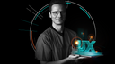 A person in medical scrubs holding a glowing digital “UX” hologram, surrounded by dynamic circular and linear graphic elements representing technology and user‑experience design.