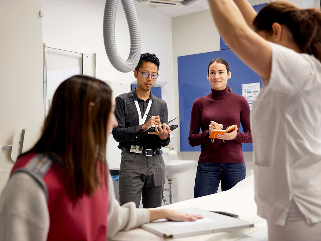Team members taking notes about the workings of a MedTech machine.