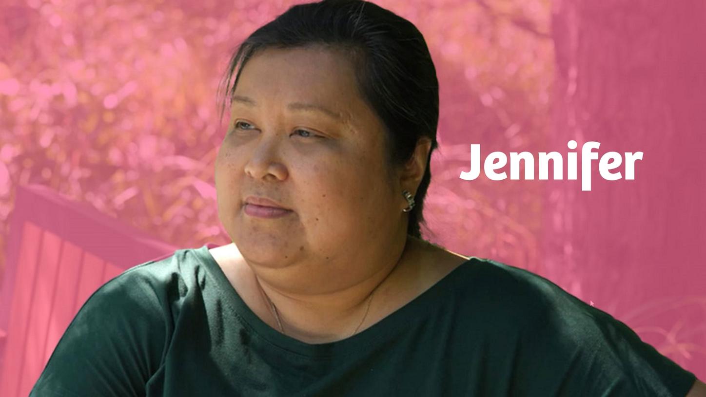 Breast cancer survivor Jennifer in front of a pink background.
