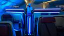 Cleaning robot disinfects an aircraft using ultraviolet light.