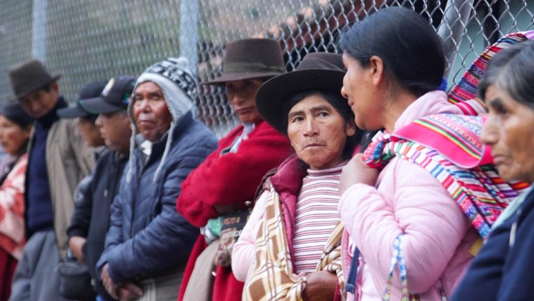 Patients in traditional dress queuing for Diospi Suyana hospital